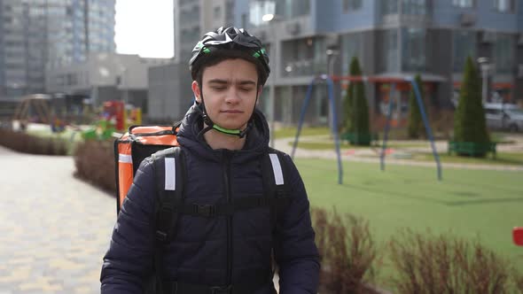 Young Male Delivering Takeout Food By Bicycle