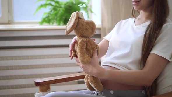 Pregnant Mother Sit with Toy on Armchair at Home and Relax Rest Spbd
