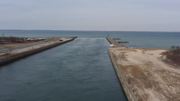 An aerial view over the Shinnecock Canal in Hampton Bays, Long Island, NY. The drone camera dolly in