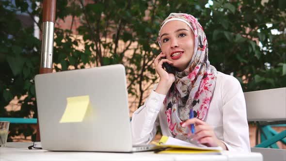 Muslim Woman Having Business Talk on Mobile