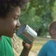 Black Male Teen Listening to Tin Can Phone Communicating With Friend, Kids Fun - VideoHive Item for Sale