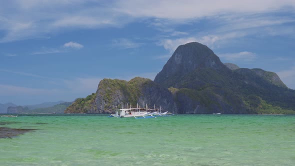 Vacation Scenery of Tourism Banca Boats Floating in Blue Ocean Lagoon. El Nido Palawan Island