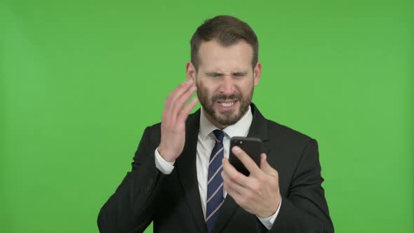 Frustrated Young Businessman Get Angry on Call Against Chroma Key