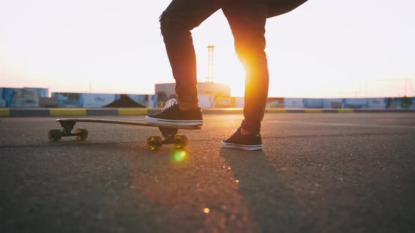 Dolly Close Up Shot of Man Riding on Longboard During Sunset Slow Motion