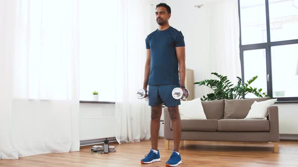 Indian Man Exercising with Dumbbells at Home