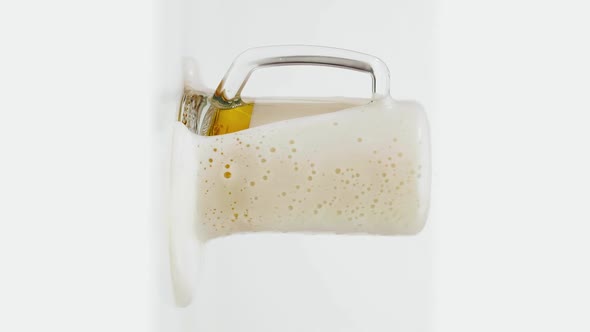 Vertical Shot of Glass of Beer with Rich Foam