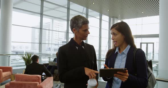 Businesswomen discussing over a digital tablet