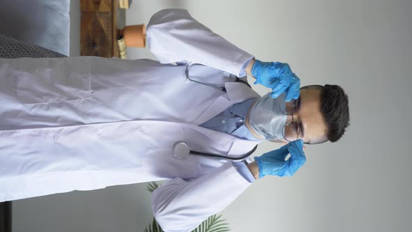 Portrait of a Young European Man Serious Doctor Takes Off his Glasses and Puts them in the Pocket