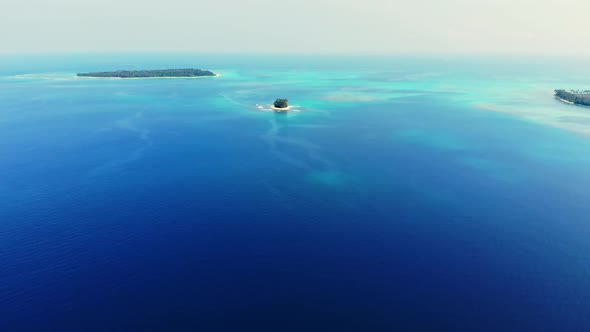 Aerial: flying over coral reef tropical islands caribbean sea turquoise blue wat