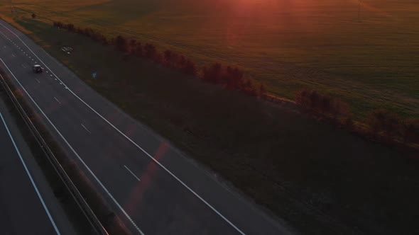 Aerial View of a Busy Suburban Highway and Beautiful Rural Landscape with Green Fields and Forest at