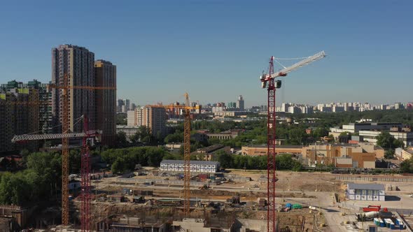 Several Tower Cranes in the Process of Building a New Residential Complex Against the Backdrop of
