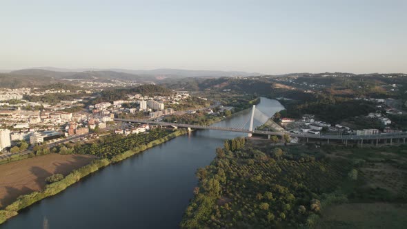 Aerial view Mondego River with Rainha Santa Isabel Bridge in the morning, Coimbra
