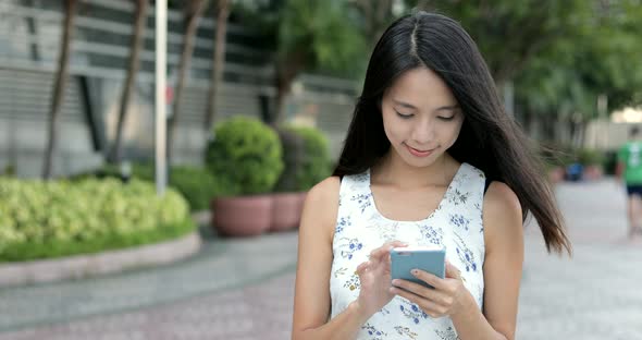Woman looking at mobile phone at outdoor 