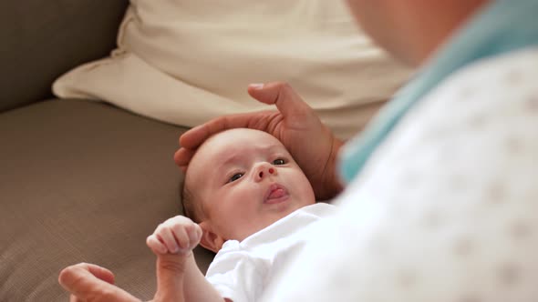 Middle Aged Father with Crying Baby at Home