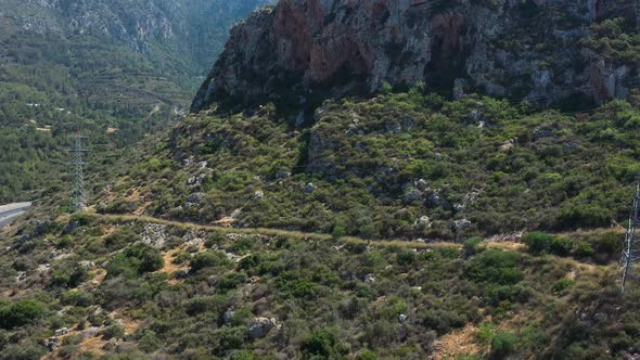 Cars travelling on a highway that winds through the mountains towards Nicosia Cyprus