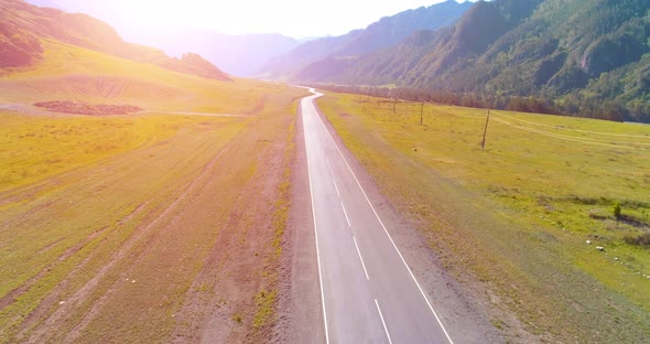 Flight Over Mountain Asphalt Highway Road and Meadow