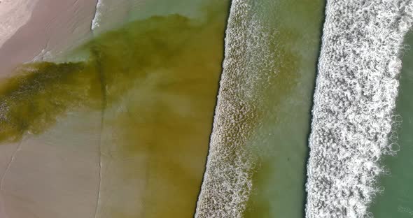 Birds eye view of water waves washing ashore  at Lagoon Beach in Cape Town South Africa