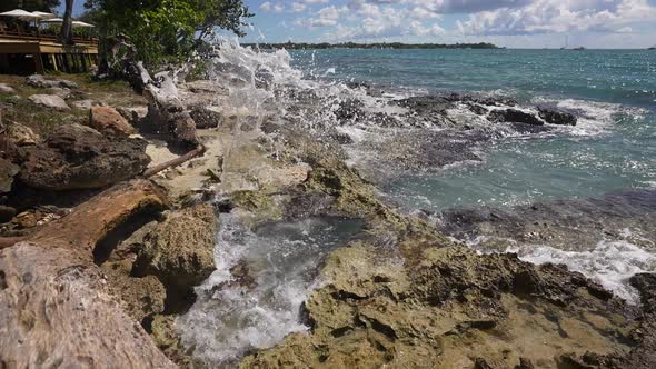 Waves Break on Rocks in a Blue Ocean