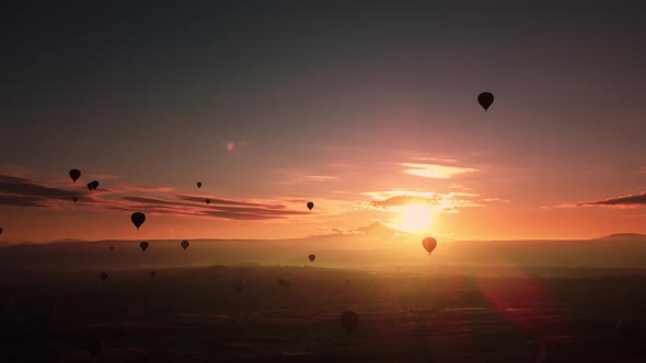 Aerial Footage of Plenty Levitating Hot Air Balloons in the Sky at Amazing Sunrise