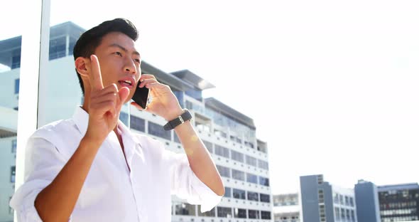 A man calling on his smartphone and pointing something