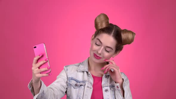 Girl Doing Selfie. Pink Background