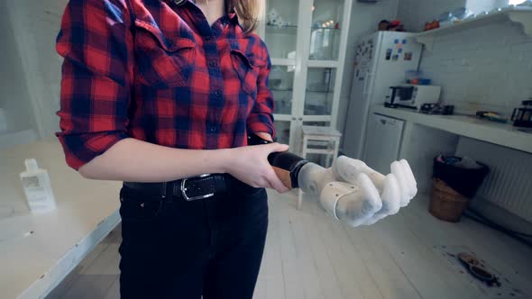 A Woman Puts on Bionic Hand, Close Up