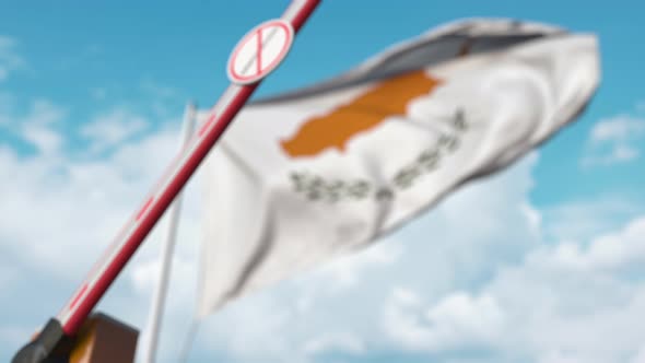 Closing Barrier with Stop Immigration Sign Against the Cypriot Flag alt