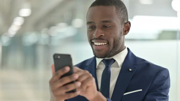 Portrait of African Businessman Using Smartphone