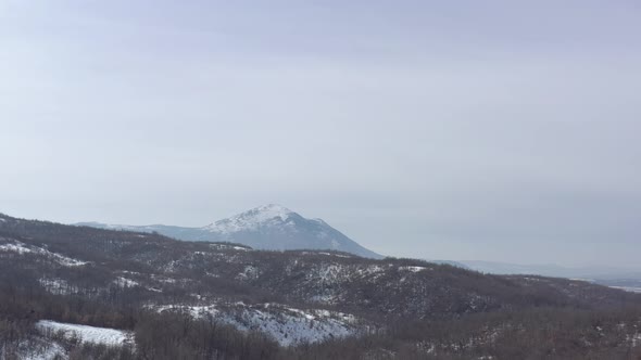 Rtanj mountain over the snowed valley 4K drone footage