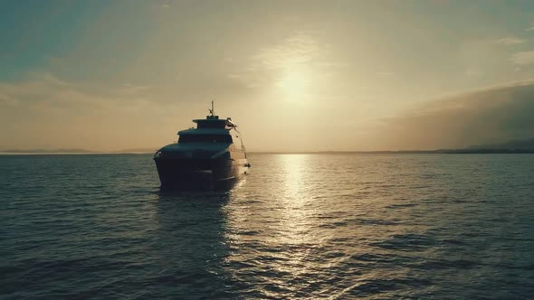 Drone footage during sunrise from an elegant boat near the coast.