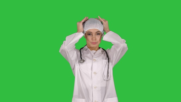 Medical doctor with stethoscope putting medical hat or