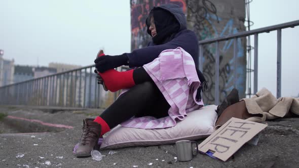 Homeless Woman Appreciate the Shoes Worn on a Thick Red Sock