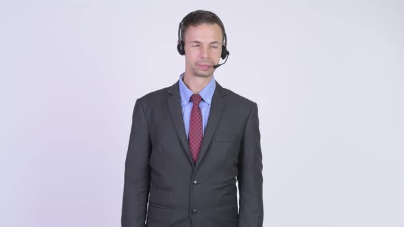 Stressed Businessman As Call Center Representative Having Headache