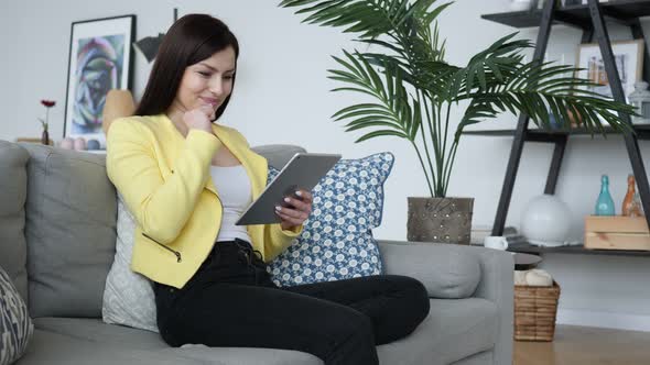 Beautiful Woman Excited for Successful Results, Reading on Tablet