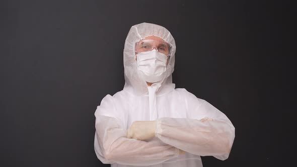 Portrait of Doctor Male in Medical Suit Posing Isolated on Black Background