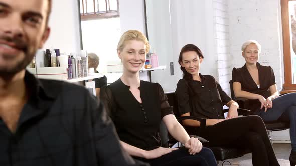 Portrait of smiling hairstylist showing thumbs up