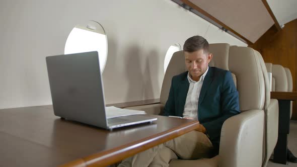 Businessman Chat and Sit in Armchair in Private Jet