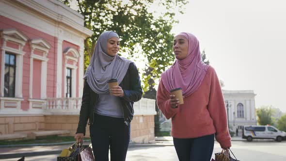 Two Muslim Darkskinned Ladies in Casual Clothes and Hijabs
