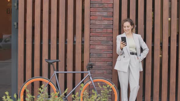 Business Woman with Bike Video Chatting Outdoors