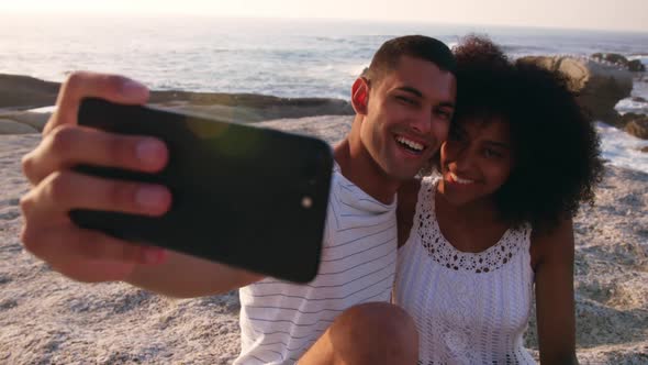 Couple taking selfie with mobile phone on the beach 4k