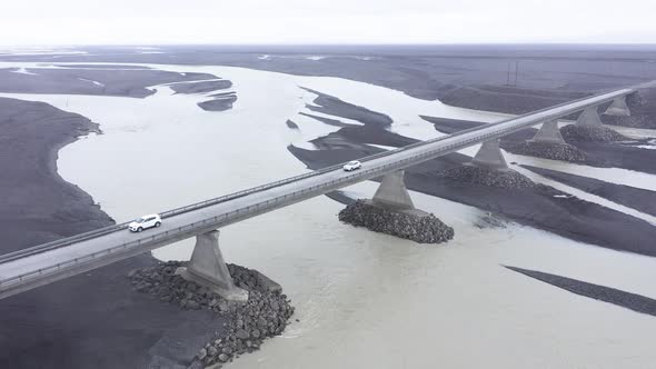 Aerial View of Cars Passing on a Bridge Road Running Through River in Iceland