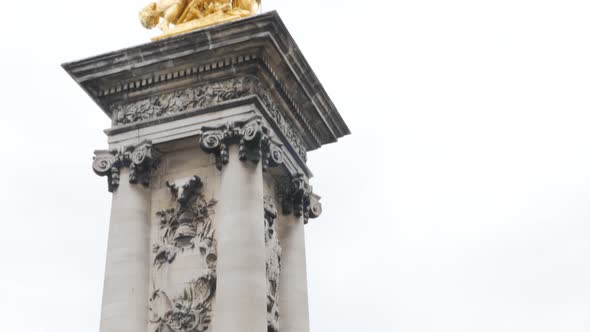 Famous Alexandre III bridge golden statues in Paris France by the day 4K 2160p UltraHD tilt footage 