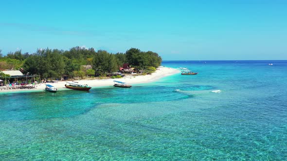 Calm crystal water of shallow lagoon with blue turquoise colors around white sand of exotic beach wh