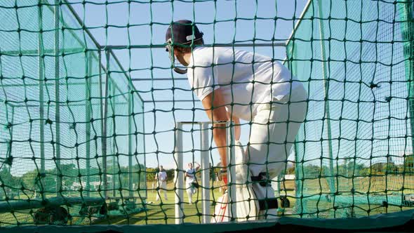 Cricket players practicing in the nets during a practice session