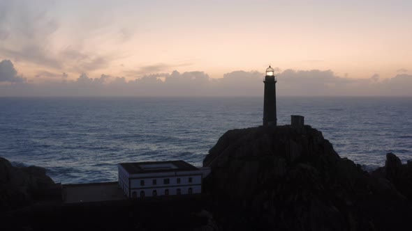 Lit Lighthouse at Dusk in Cape Vilan Galicia Spain Aerial View