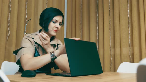 Woman Completes Work on Laptop