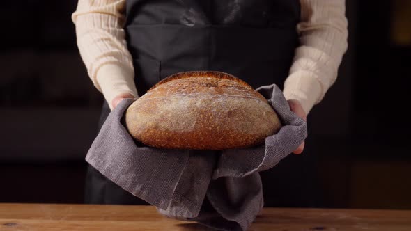 Female Baker with Homemade Bread at Bakery