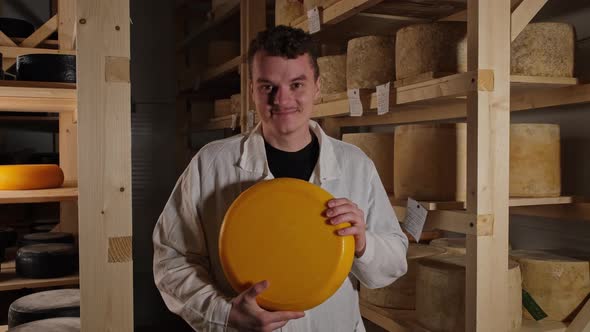 Happy Man Holding Big Cheese Head At Storage