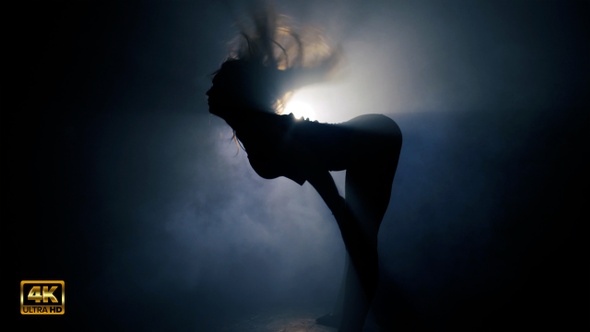 Sexy Women Dancing In Smokey Beam Of Light With Steadicam Movement