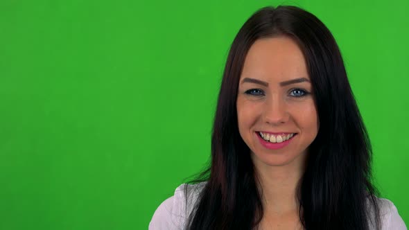 Young Pretty Woman Winks with Eye - Green Screen - Studio